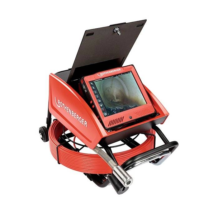 Red drain inspection device with an integrated camera and monitor, displaying the interior of a pipe.