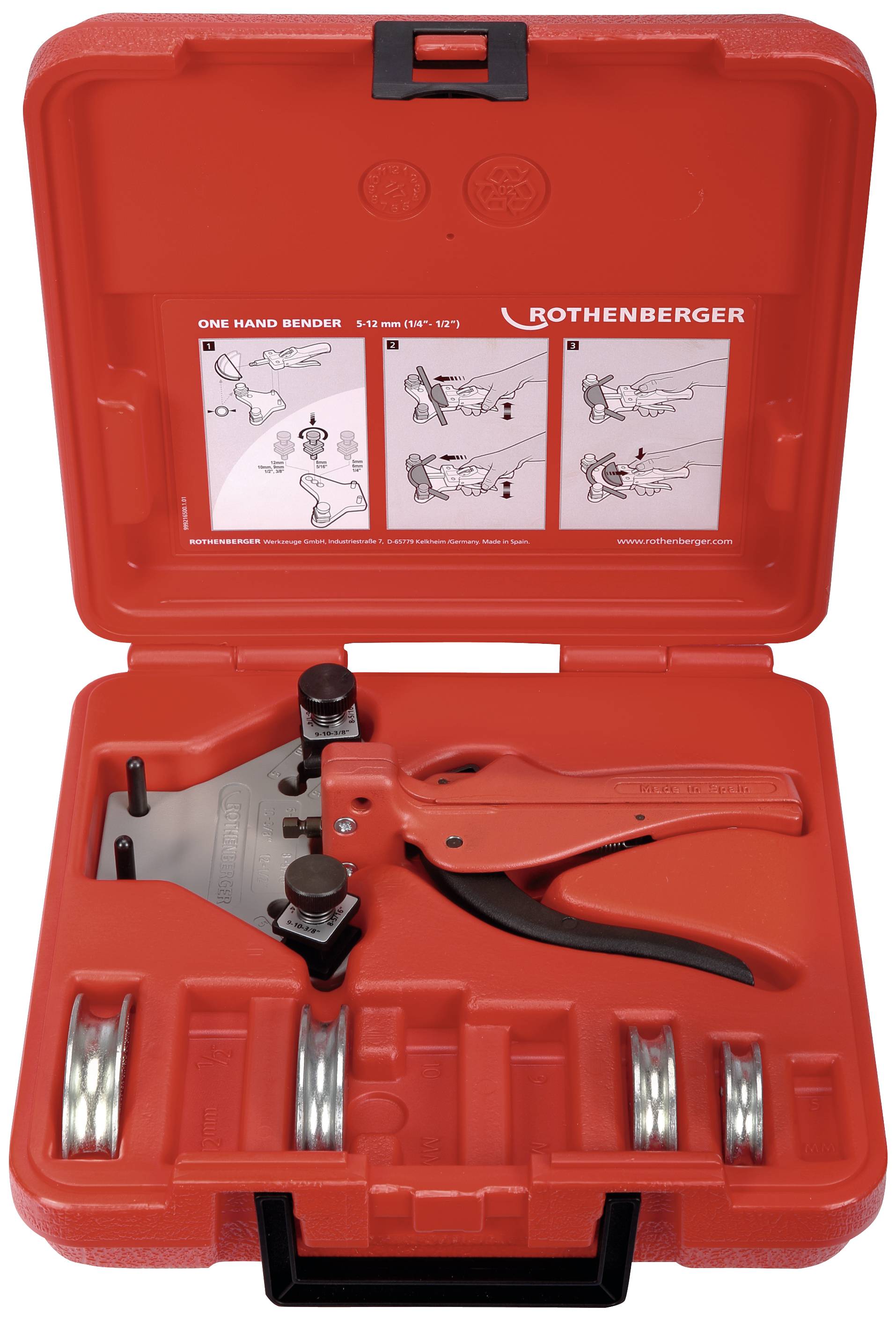 A red plastic case containing a pipe bending machine and several bending segments. Instructions are affixed to the inside of the lid.