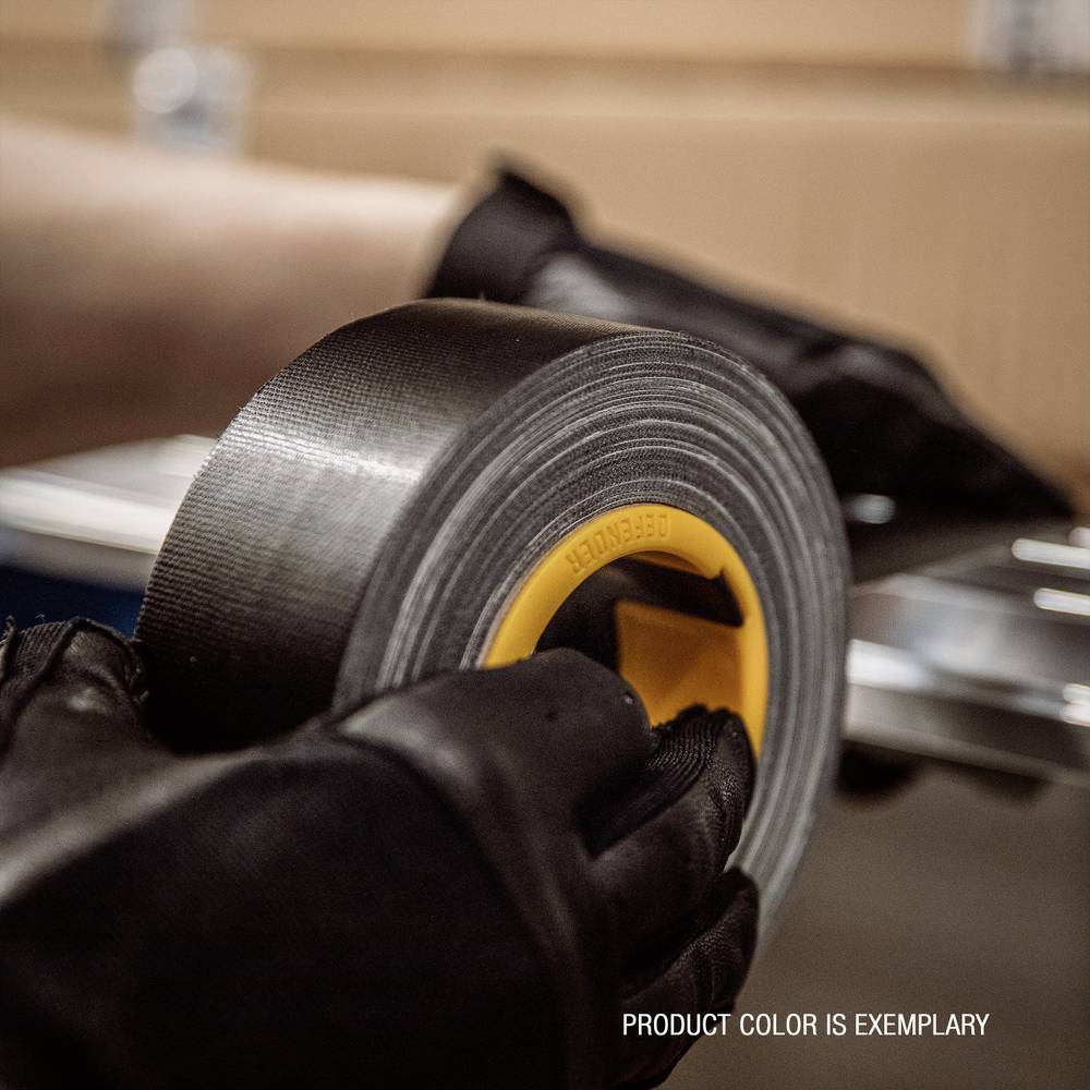 A person is holding a roll of adhesive tape. Blurred objects can be seen in the background. The text 'Product colour is exemplary' is located in the bottom right.