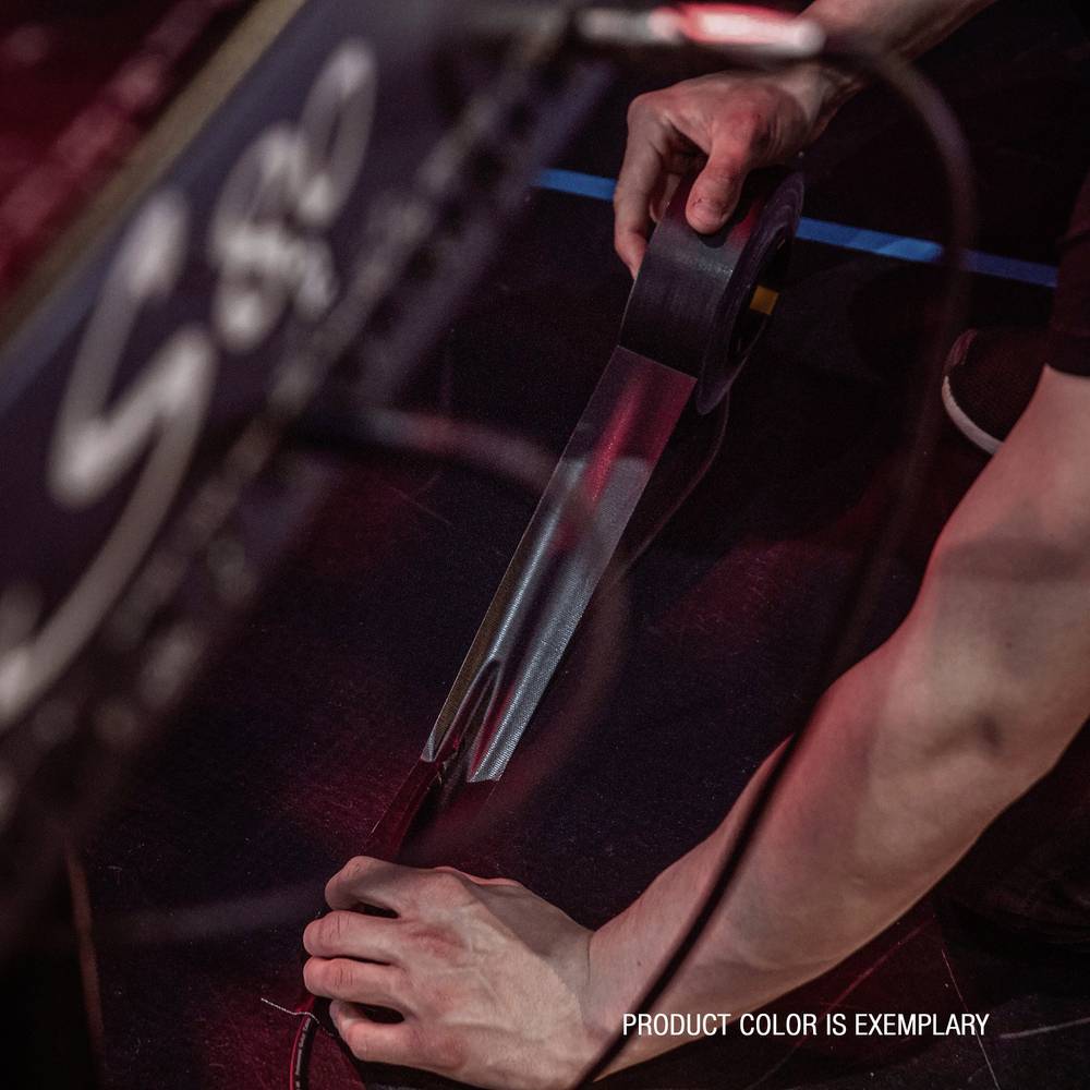 A person is holding a roll of sellotape and cutting off a piece of tape.