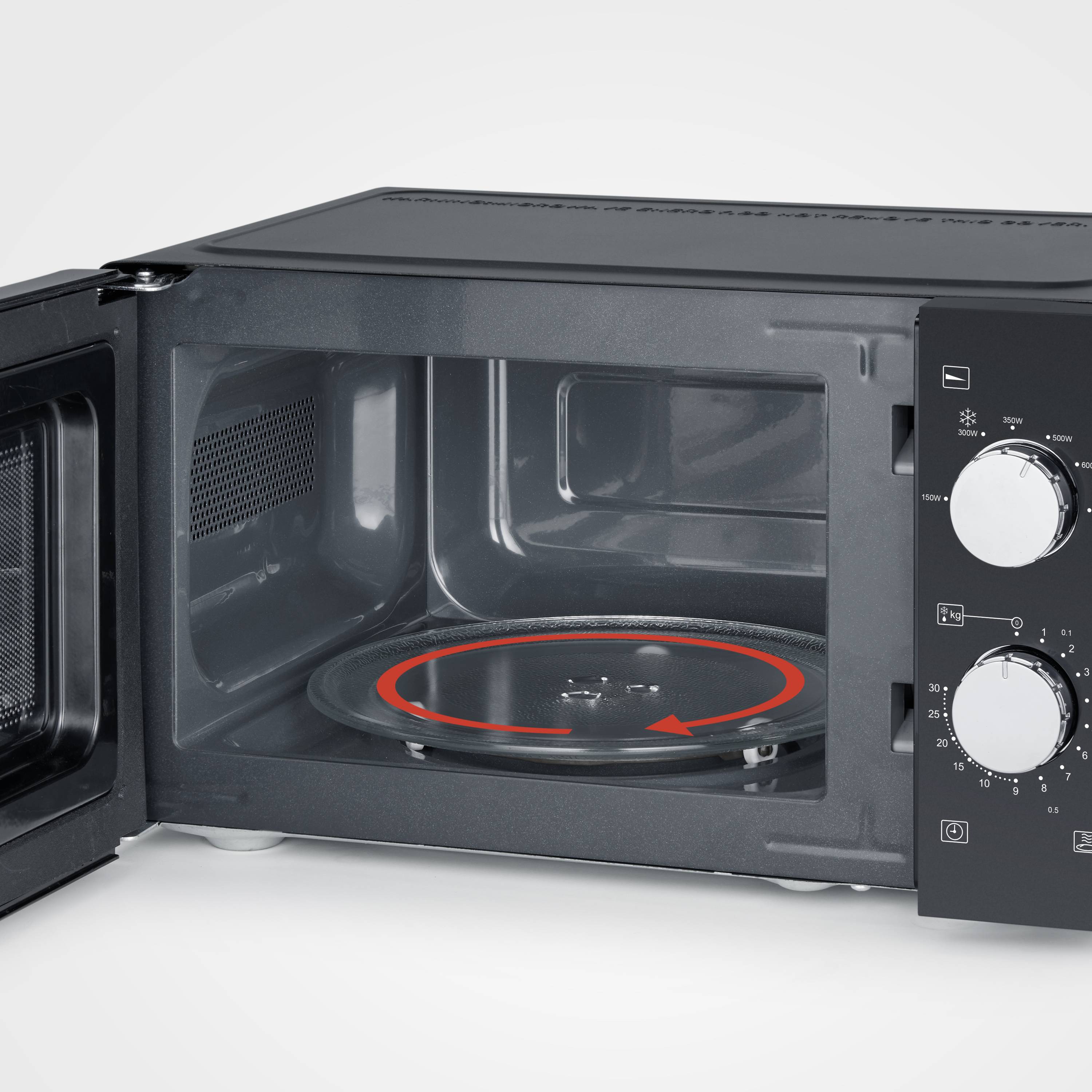 An open microwave with a turntable inside. Two rotary knobs on the right-hand side control time and power.