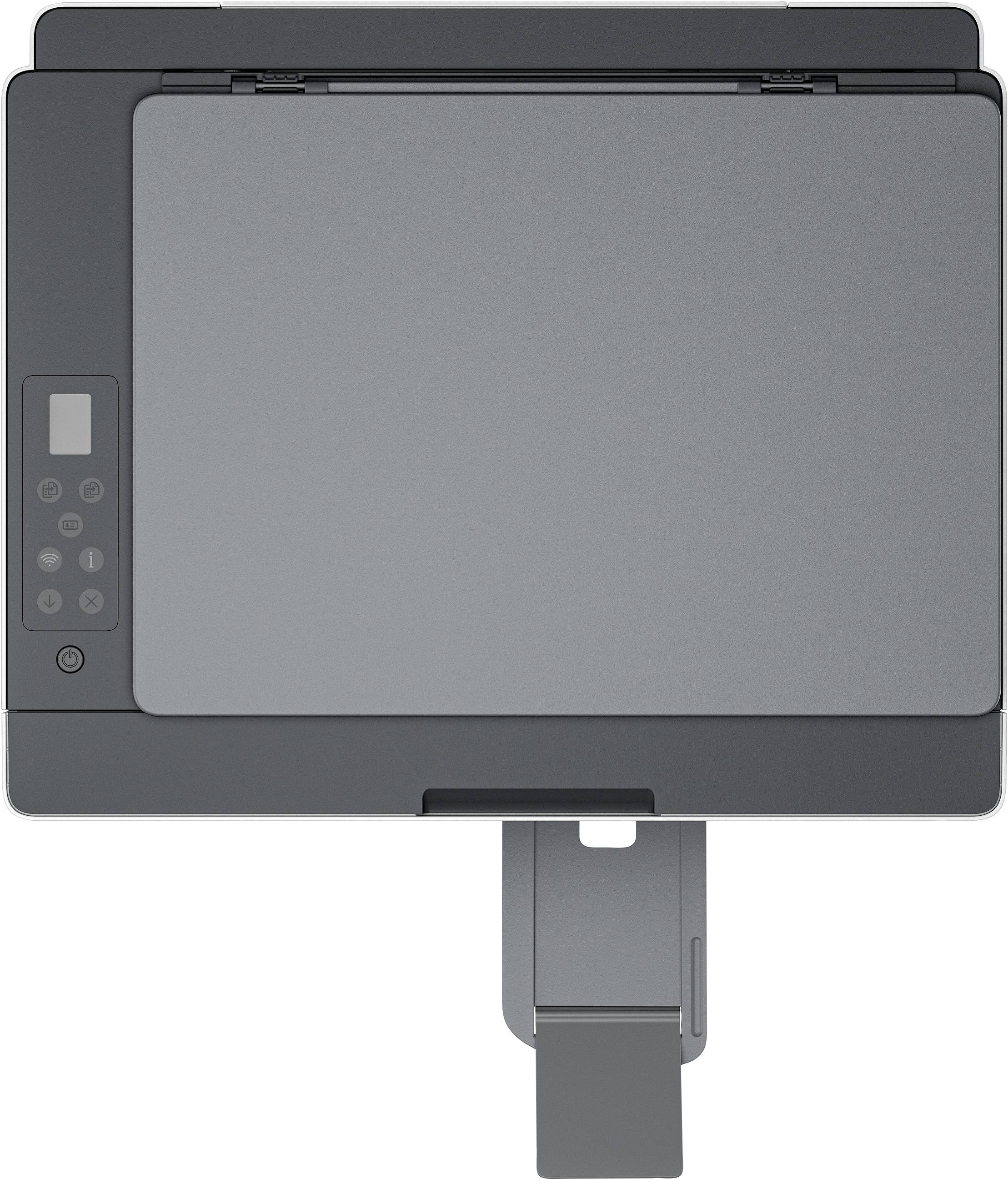 A modern, grey photocopier viewed from above, with control buttons on the left side and an open paper output tray at the bottom edge.