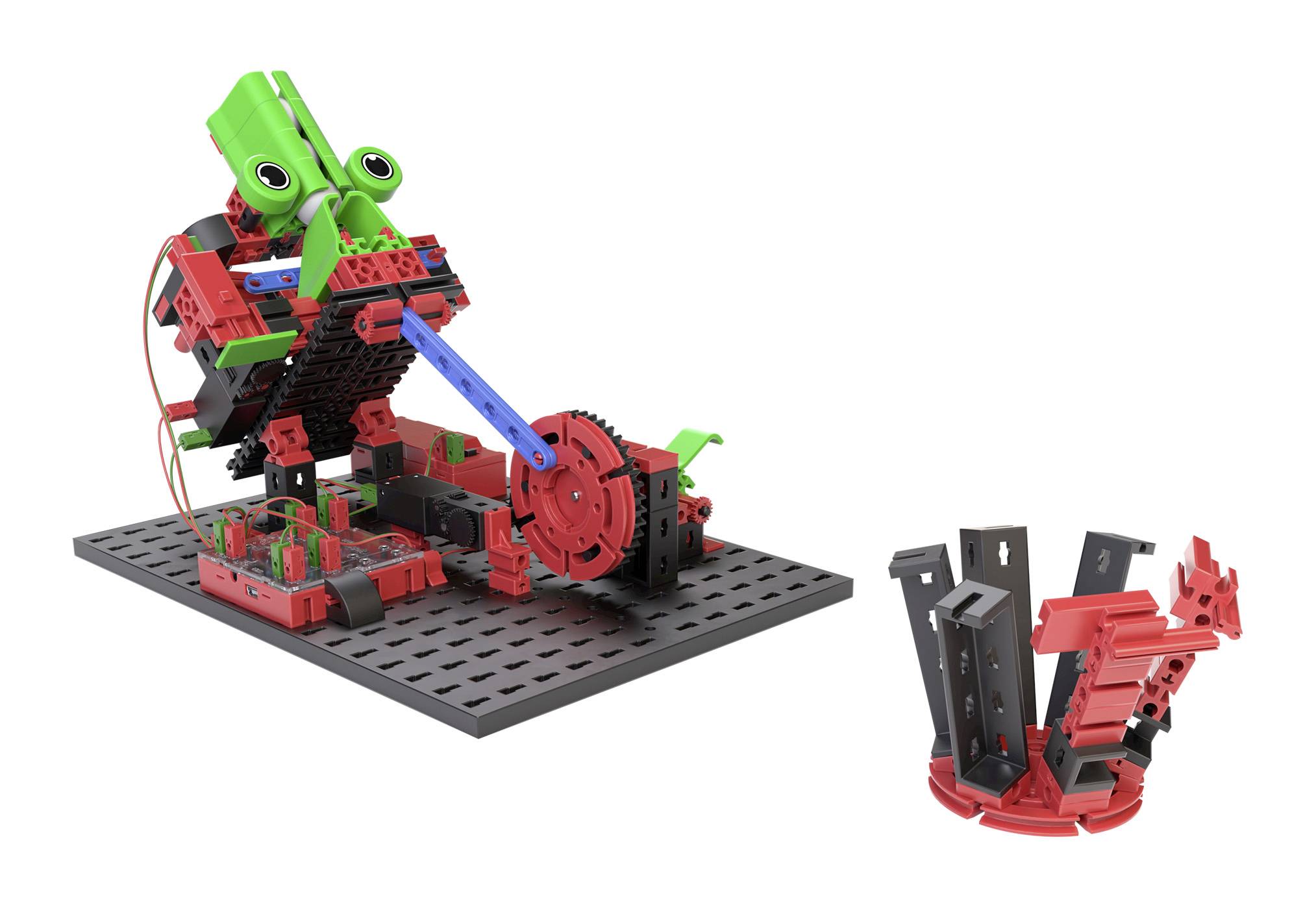 Robot made from red and black Lego pieces with green elements, mounted on a black base plate. Additional components are placed nearby.