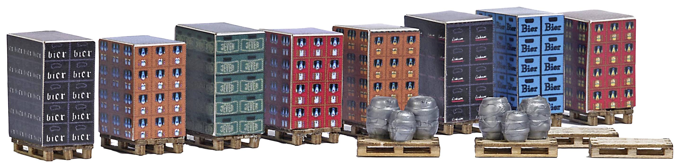 Several pallets with crates and barrels, painted to look like buildings. Various colours and inscriptions are visible on the pallets.