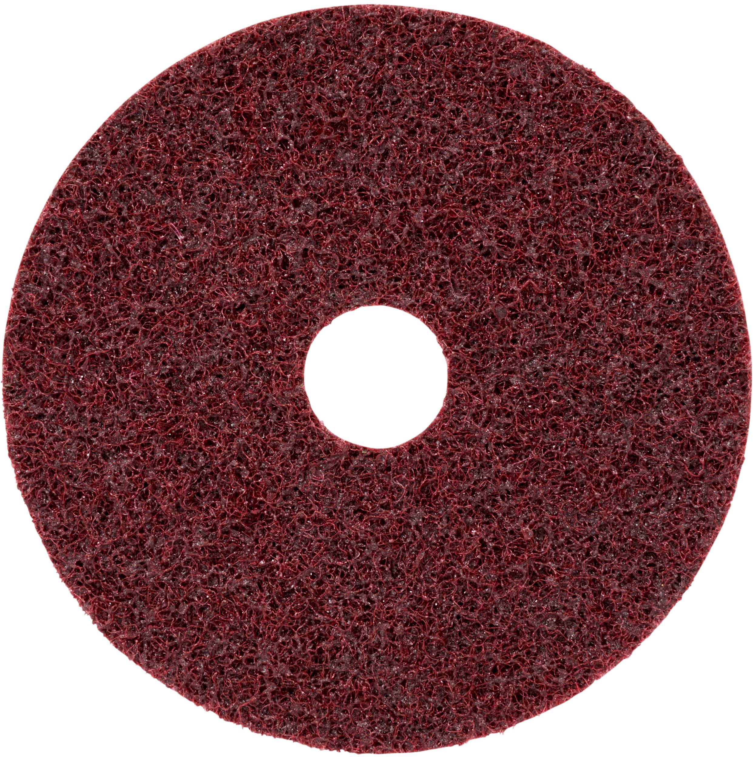 A red, circular scouring pad with a hole in the centre, suitable for cleaning or polishing surfaces.