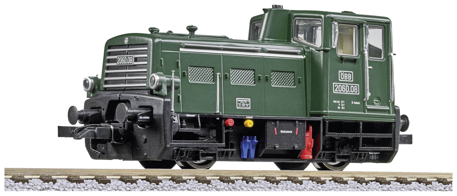 A green model of a diesel locomotive stands on railway tracks. It bears the inscription '2060.08' and has distinctive details and lights.