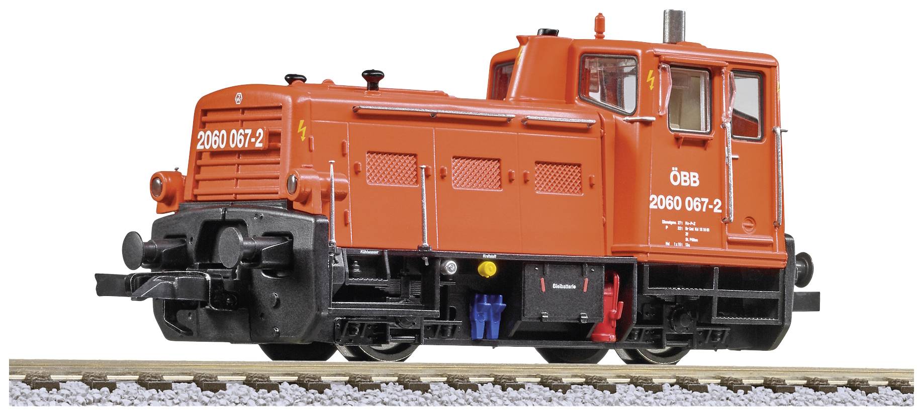 A red ÖBB diesel locomotive with the number '2060 067-2' is standing on a track. The locomotive has a compact design.