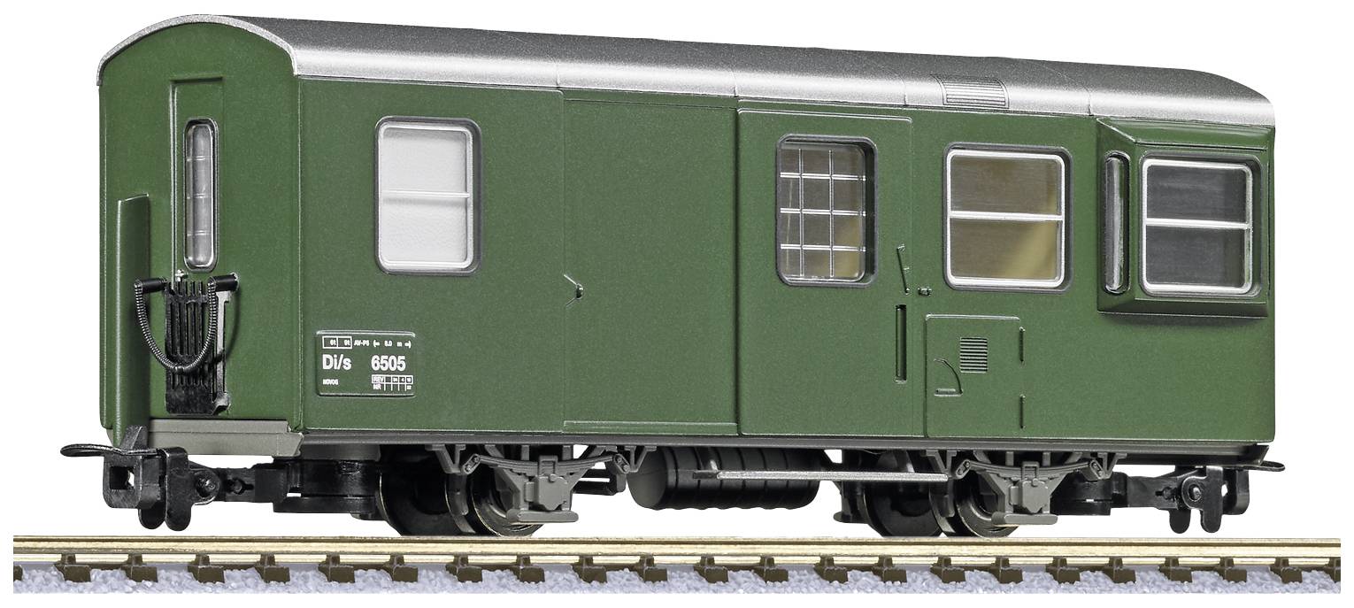 A green model railway goods wagon on a track.