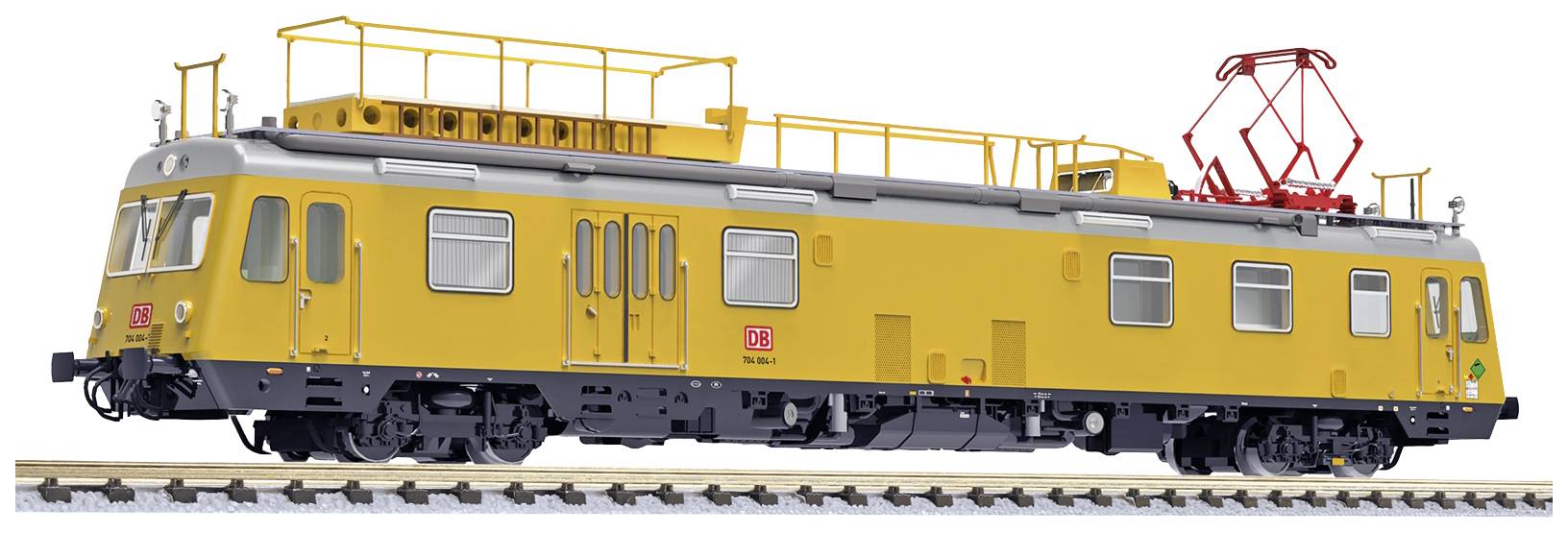 Yellow maintenance train of Deutsche Bahn on railway tracks. The train has a flat roof with technical installations and is equipped for maintenance work.