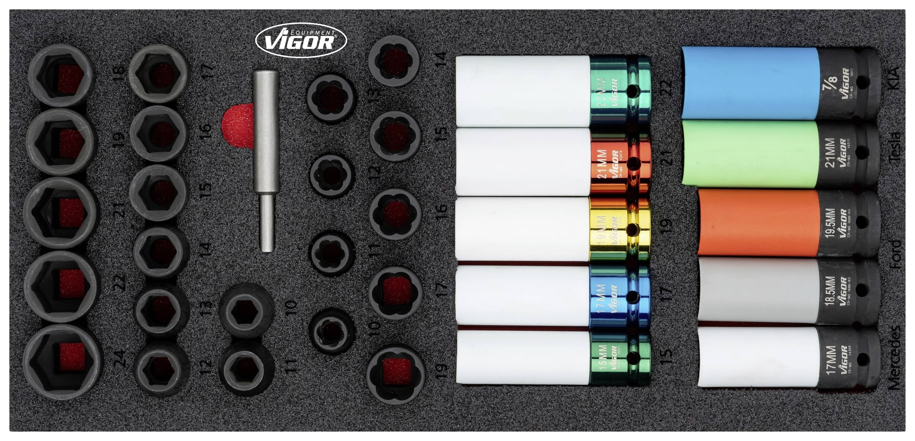 Set of drawing pins in various sizes and colours stored in a foam organiser. On the left are hexagonal compartments, on the right are colourful drawing pins.