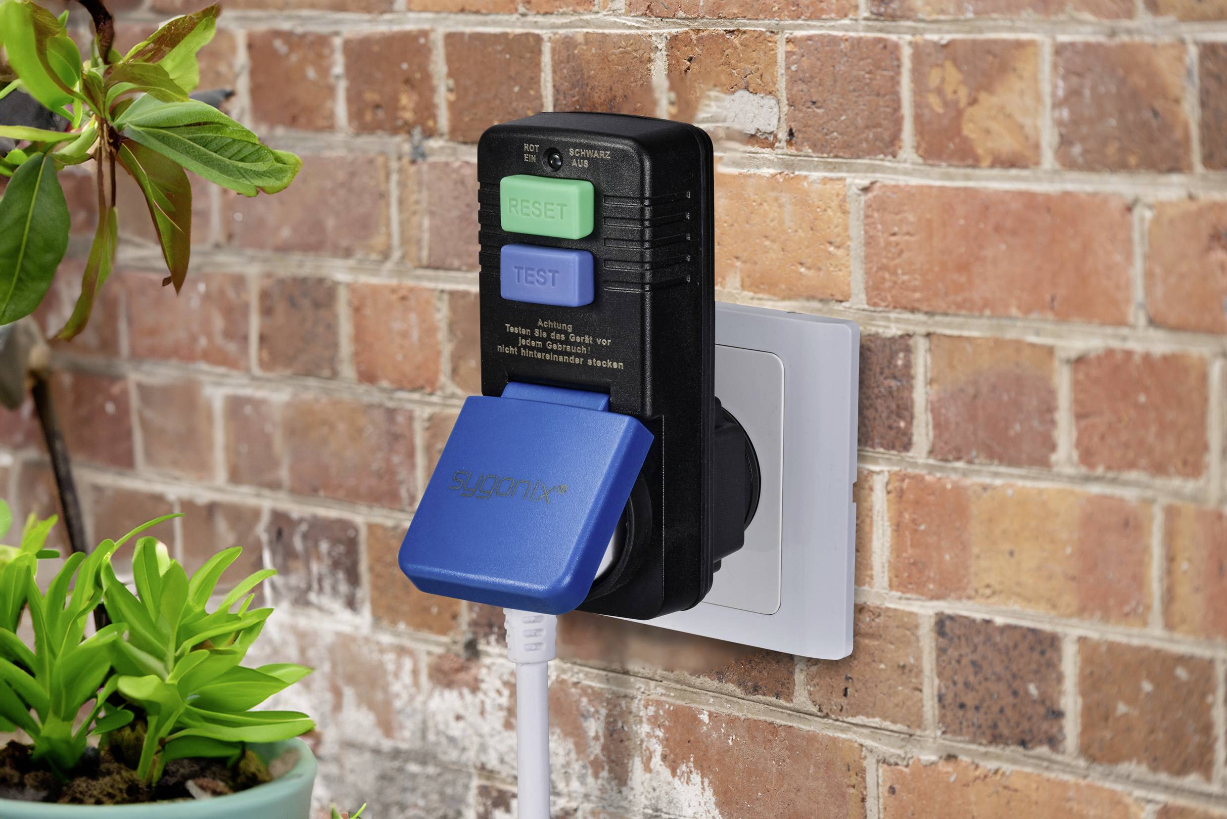 A surge protector with test and reset button is plugged into a wall socket. A blue charger is connected.
