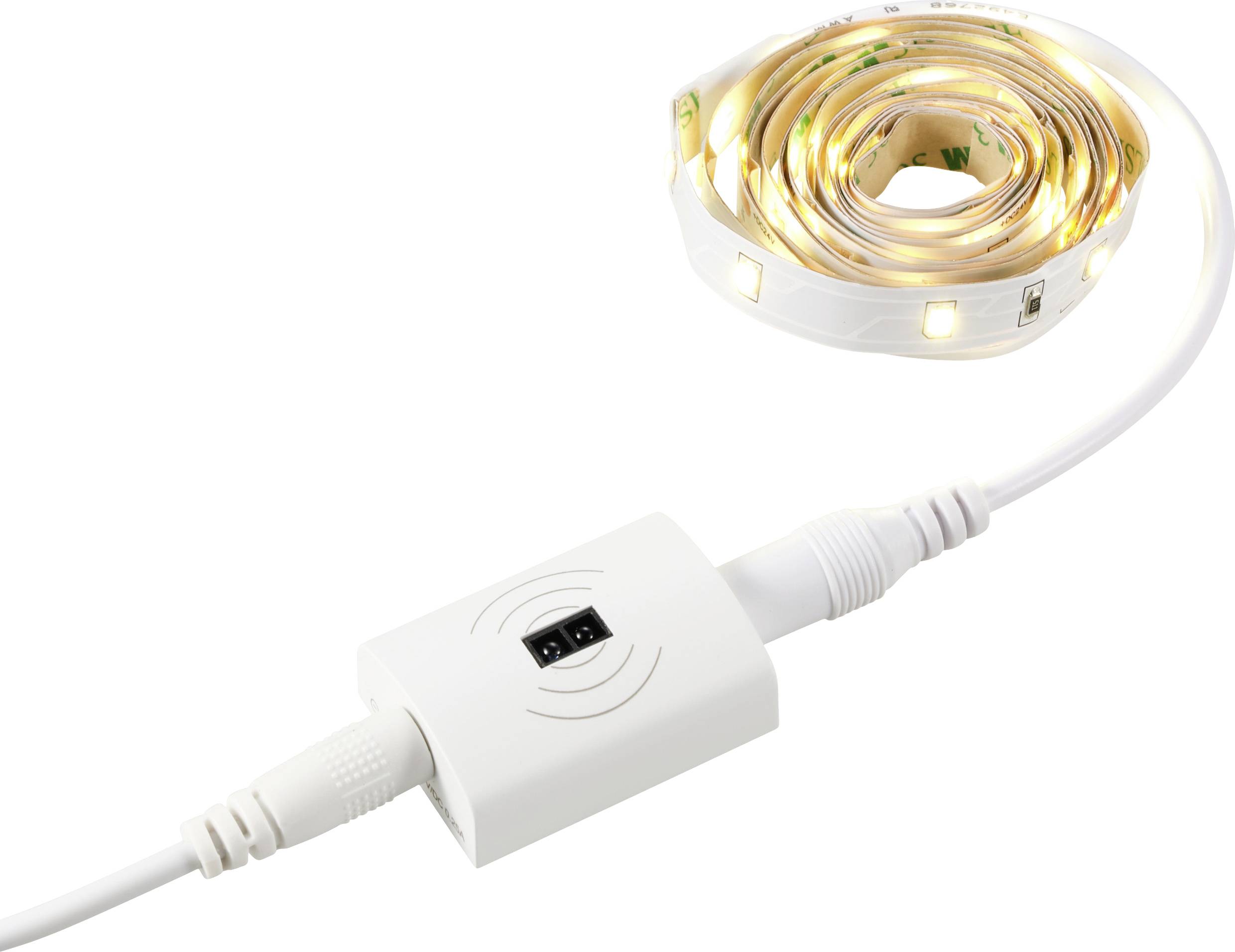 A coiled LED light strip with a connected adapter shows the connection to a power source for lighting.