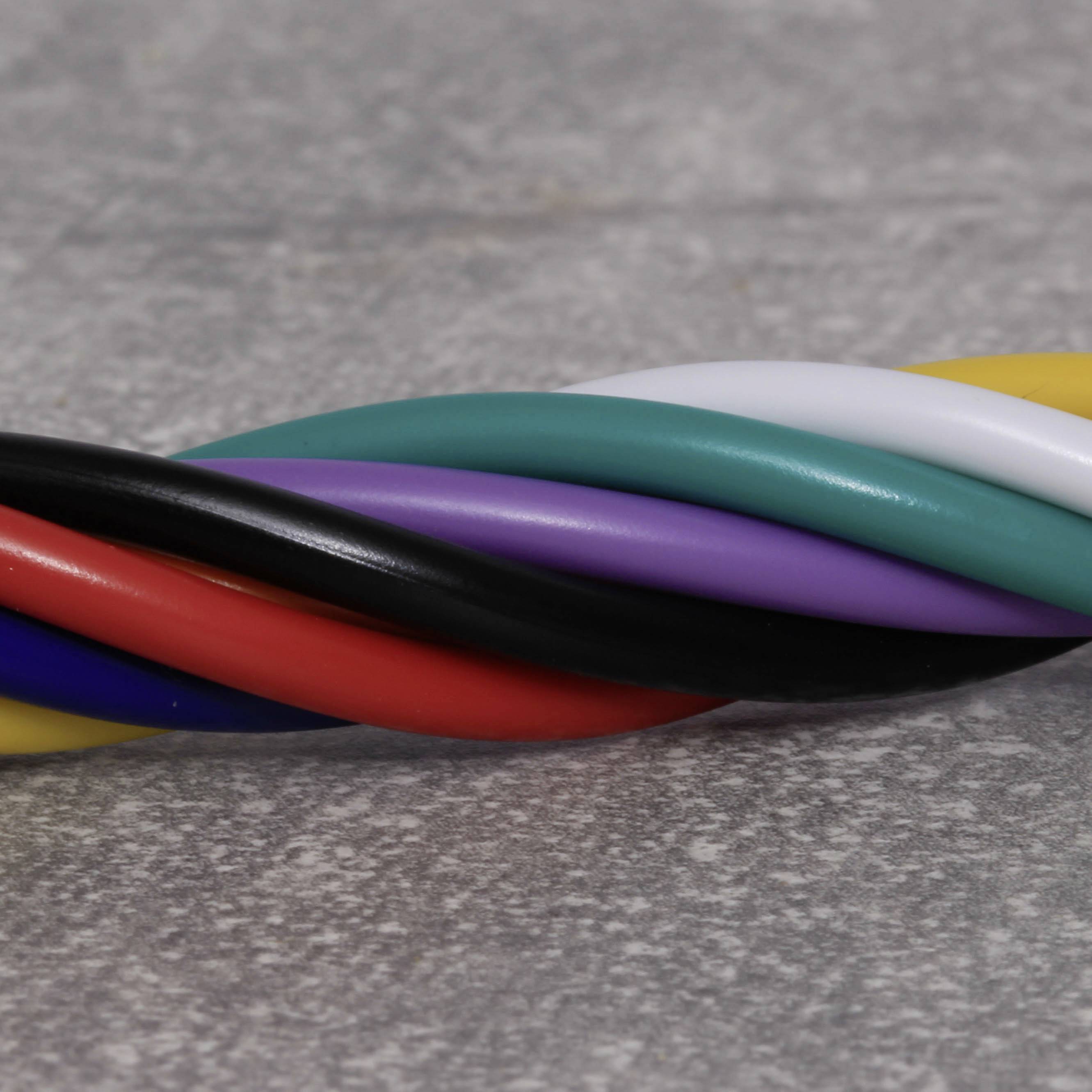 Multicoloured helix of cables; red, black, purple, green and white strands on a grey background, symbolising interconnectivity.