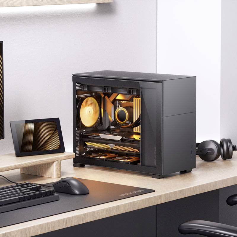 A modern PC with illuminated fans sits on a desk next to a monitor. The scene depicts a minimalist workspace.