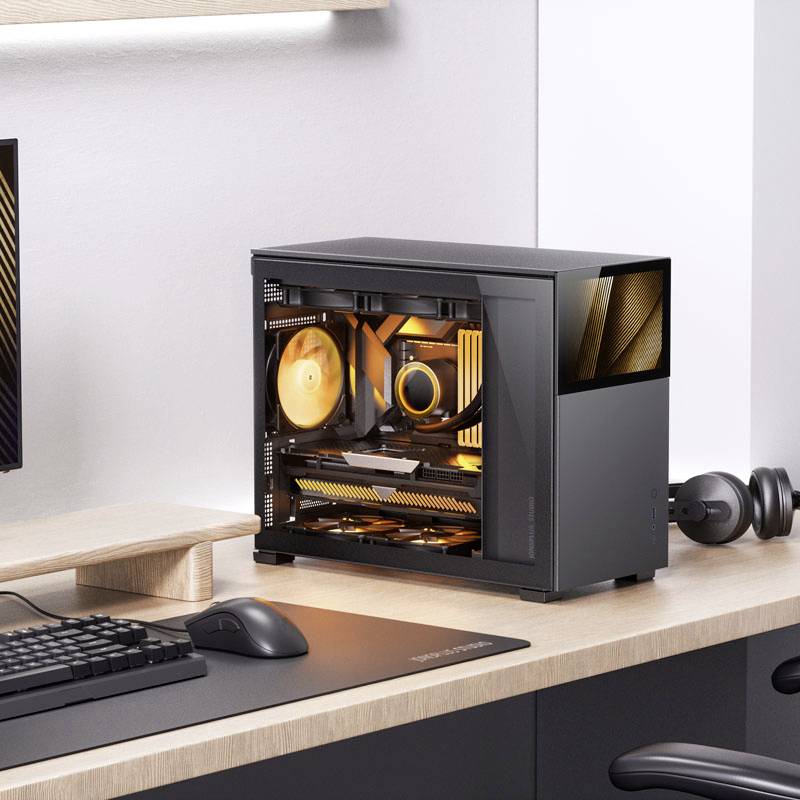 A small desktop PC sits on a desk, revealing illuminated internal components through a transparent side panel.
