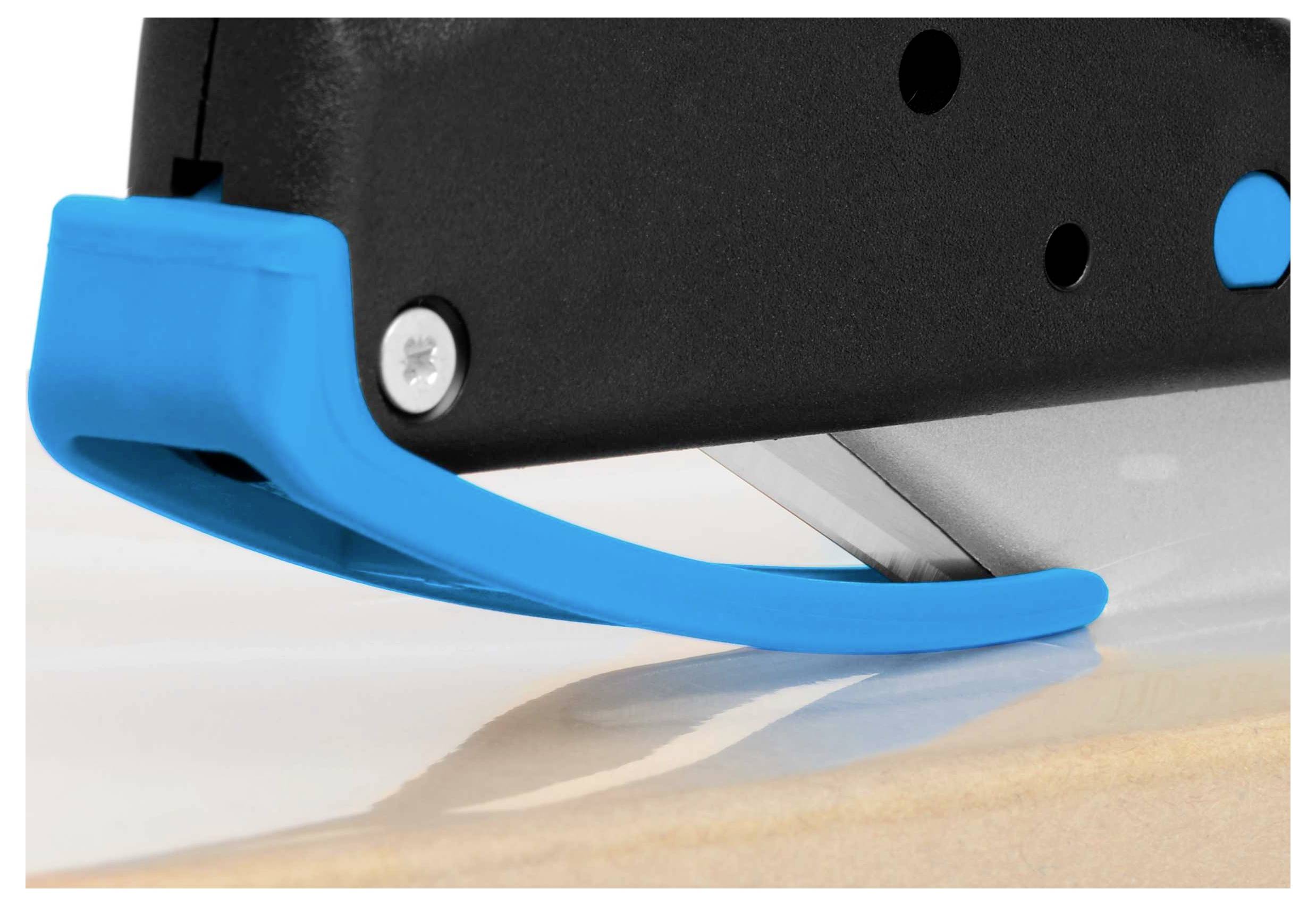 A blue stapler stapling a sheet of paper onto a wooden surface. The focus is on the stapler and the action.