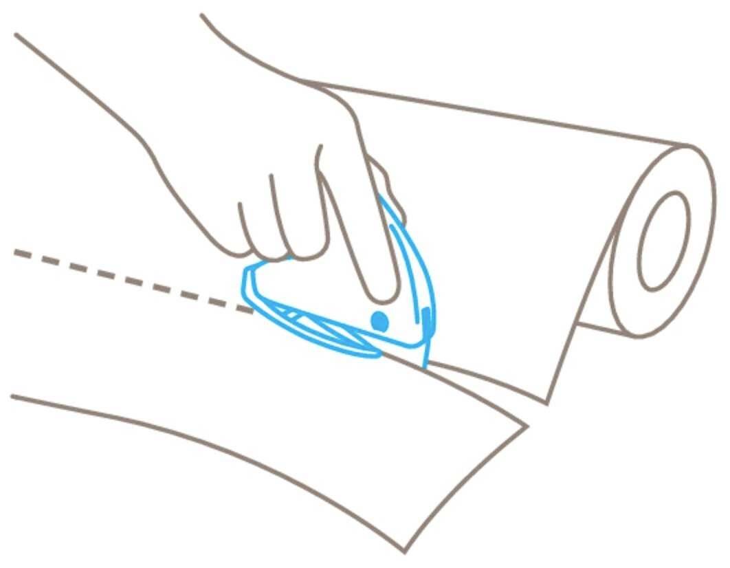 A hand is using a blue cutter to cut paper from a roll along a dotted line.