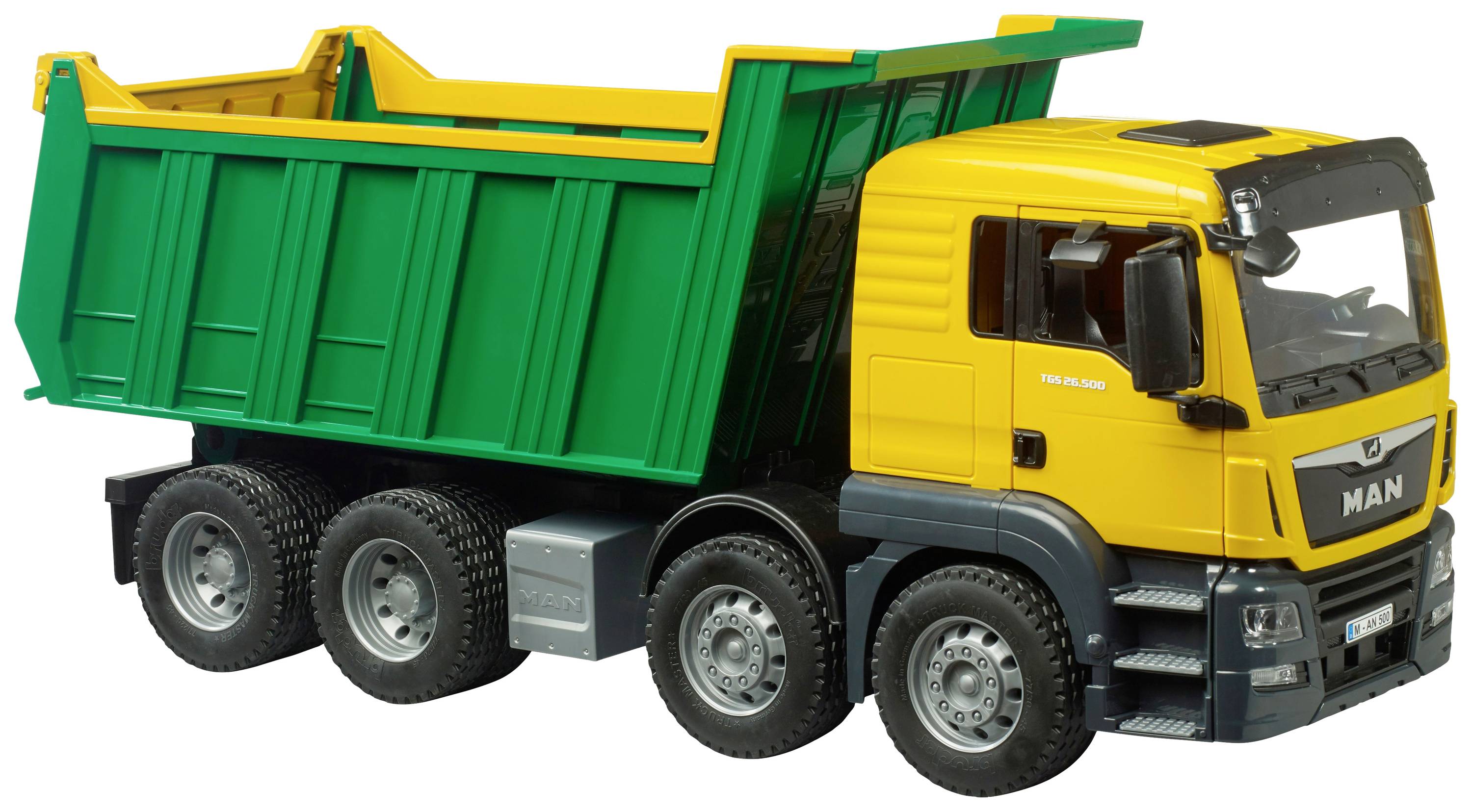 Yellow lorry with green tipper body, suitable for transporting heavy loads. Exterior view, four axles.
