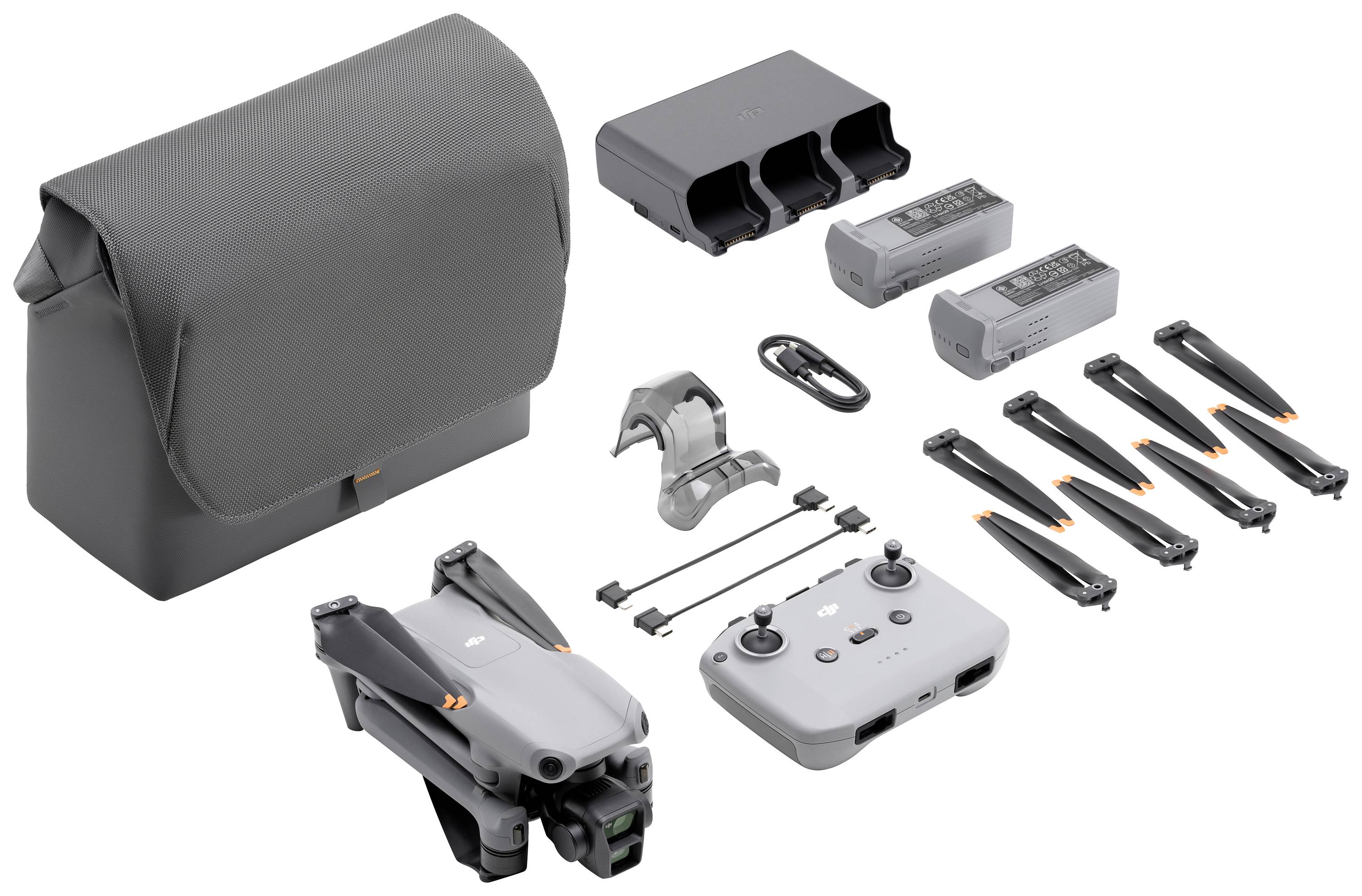 Drone kit consisting of a drone, remote control, two batteries, charger, bag, propellers, and accessories. Ideal for photography.