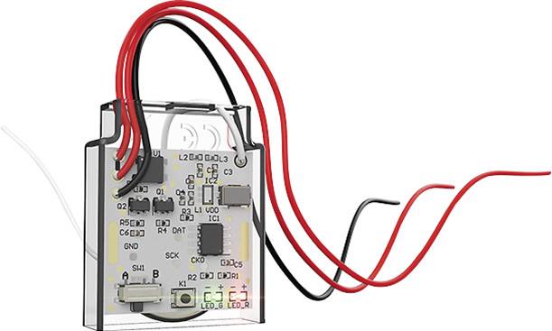 An electronic control unit with red and black cables, showing circuit board elements and integrated chips, used for electronic circuits.