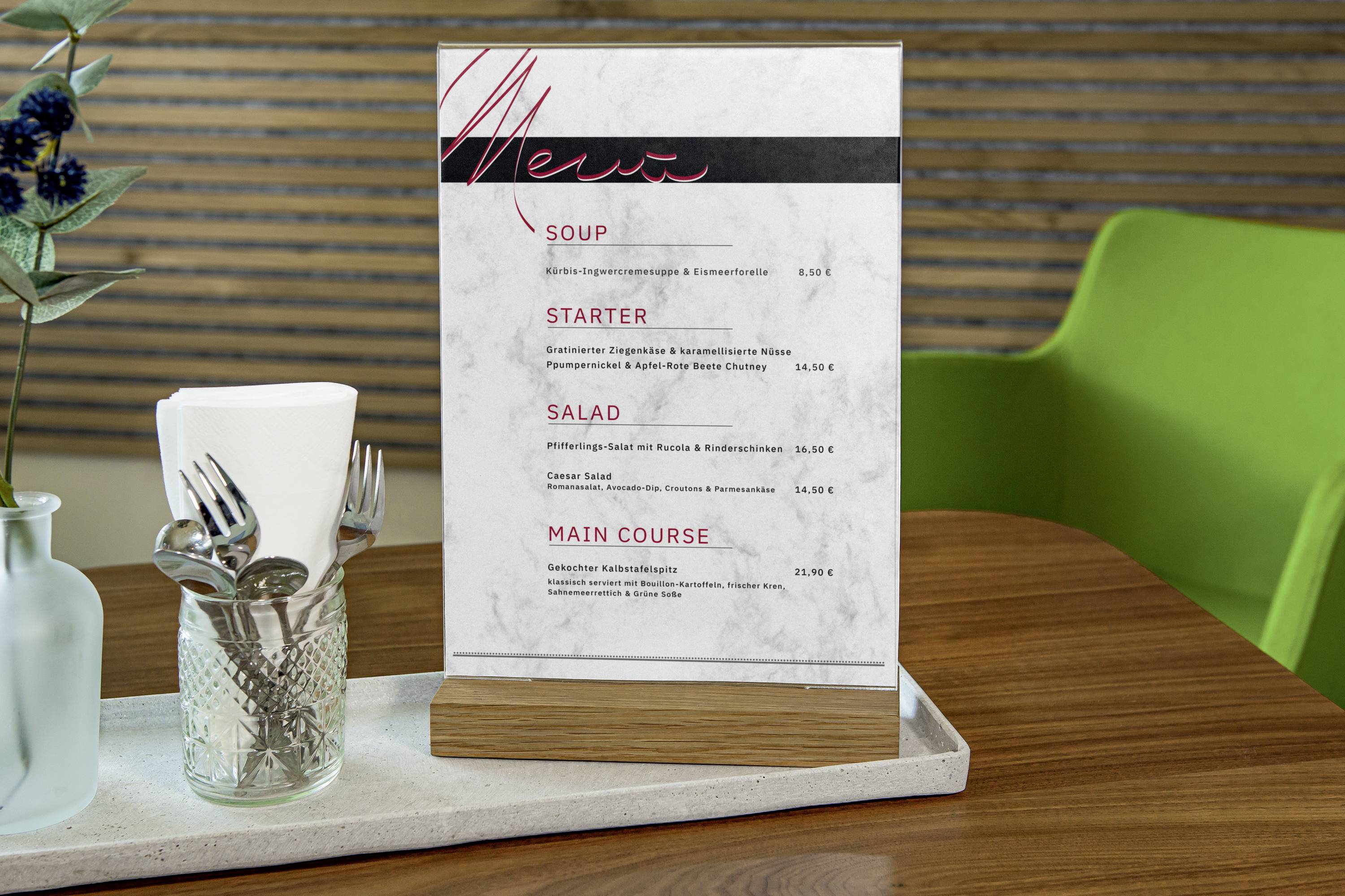 Menu sitting on a table in a restaurant. Contains categories such as 'Starters' and 'Main Course' with prices in Euros.