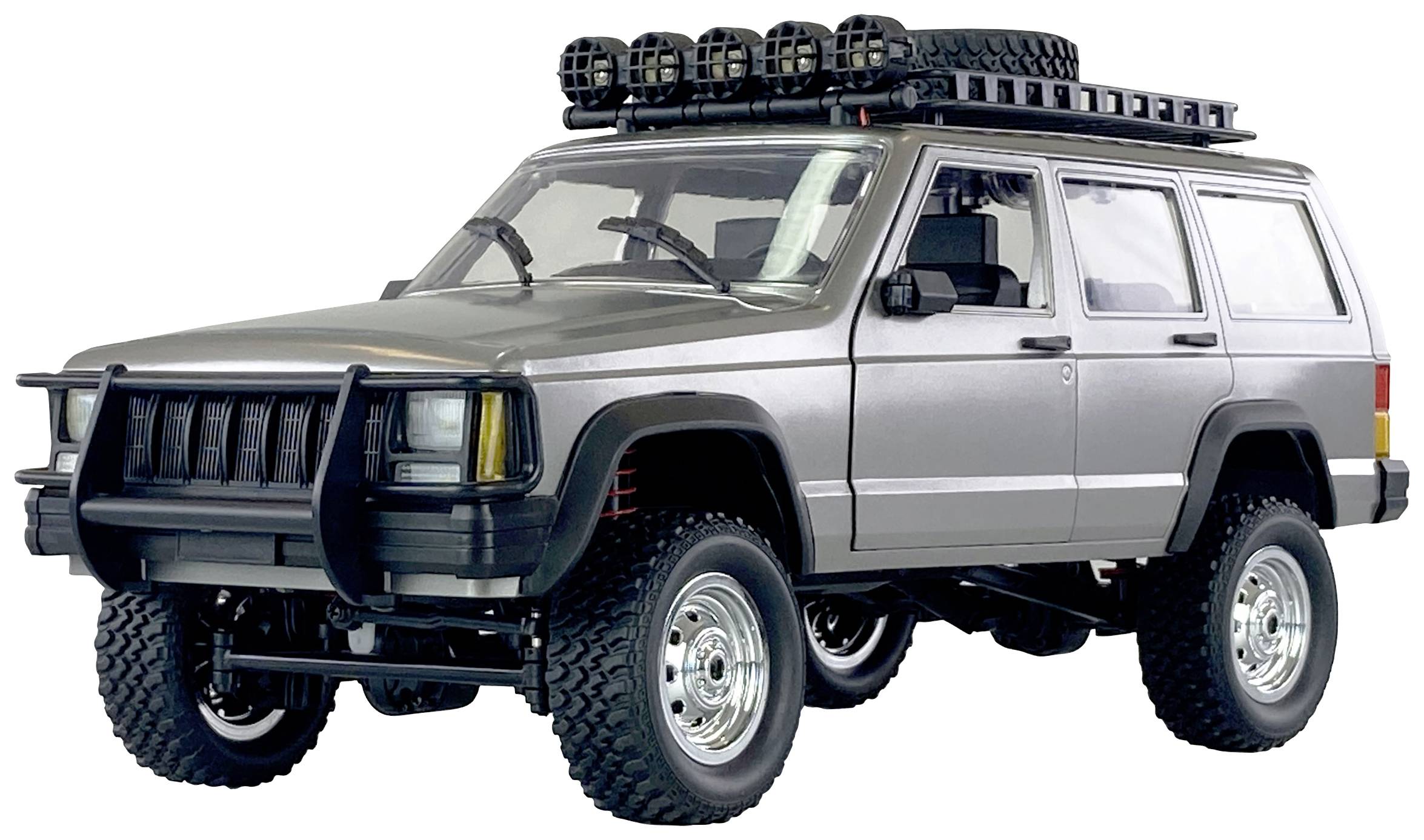 Off-road vehicle stands sideways. Roof rack with spare wheel and additional headlamps. High ground clearance.