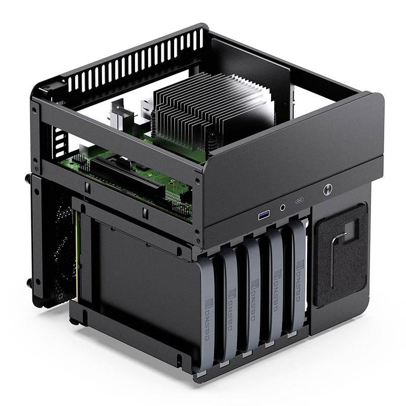 An open gaming PC with visible components: processor with large heatsink, motherboard and hard drive frame with four slots.