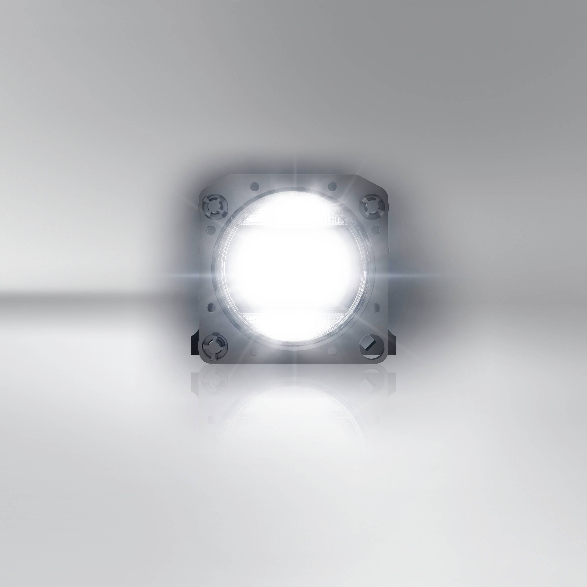 A bright LED light on a reflective surface. It emits intense light with a dazzling effect.