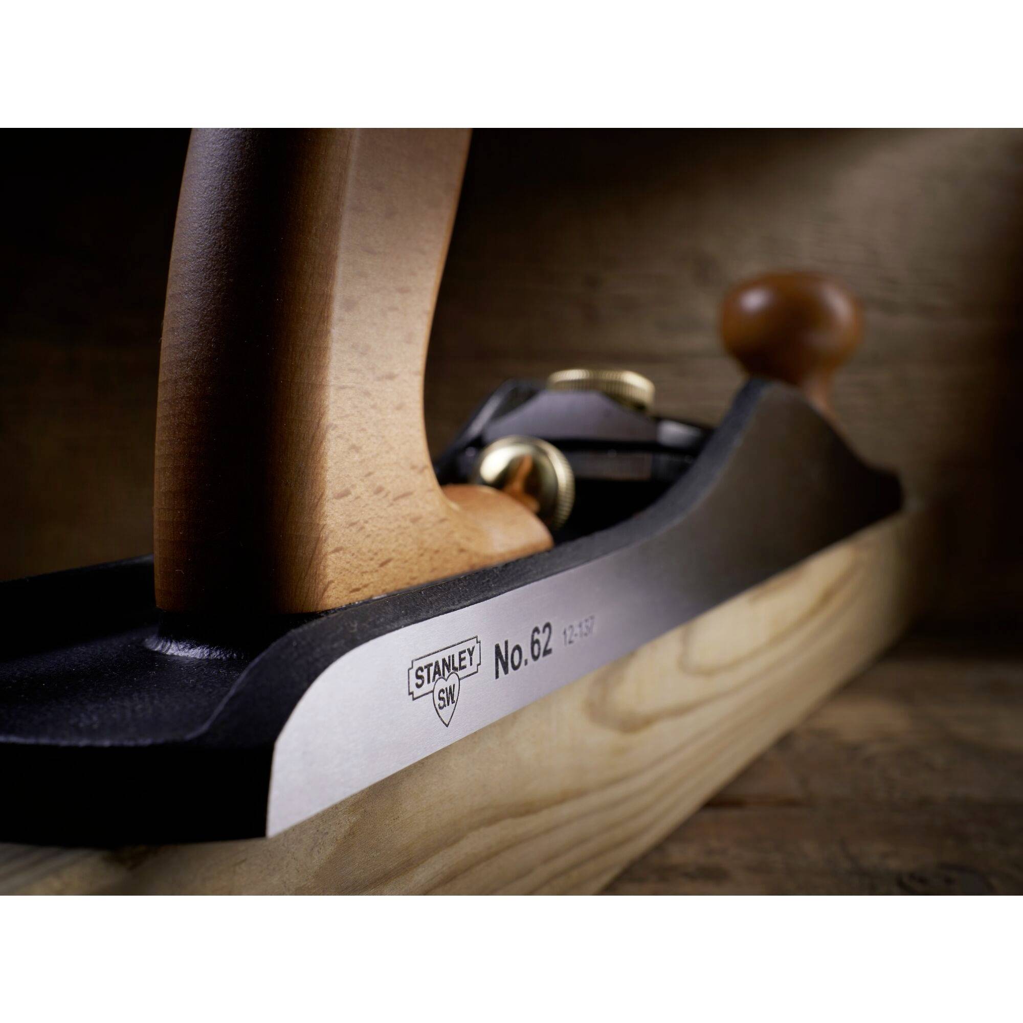 Wooden plane on a wooden background, focused on the side number 'No. 62'. Ergonomic wooden handle, sturdy metal casing.