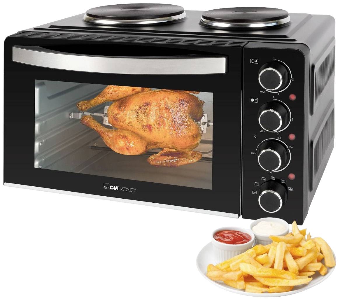 Black oven with two hotplates on top and rotary knobs; a roast chicken is turning inside the oven. A plate with chips and sauces is placed beside it.