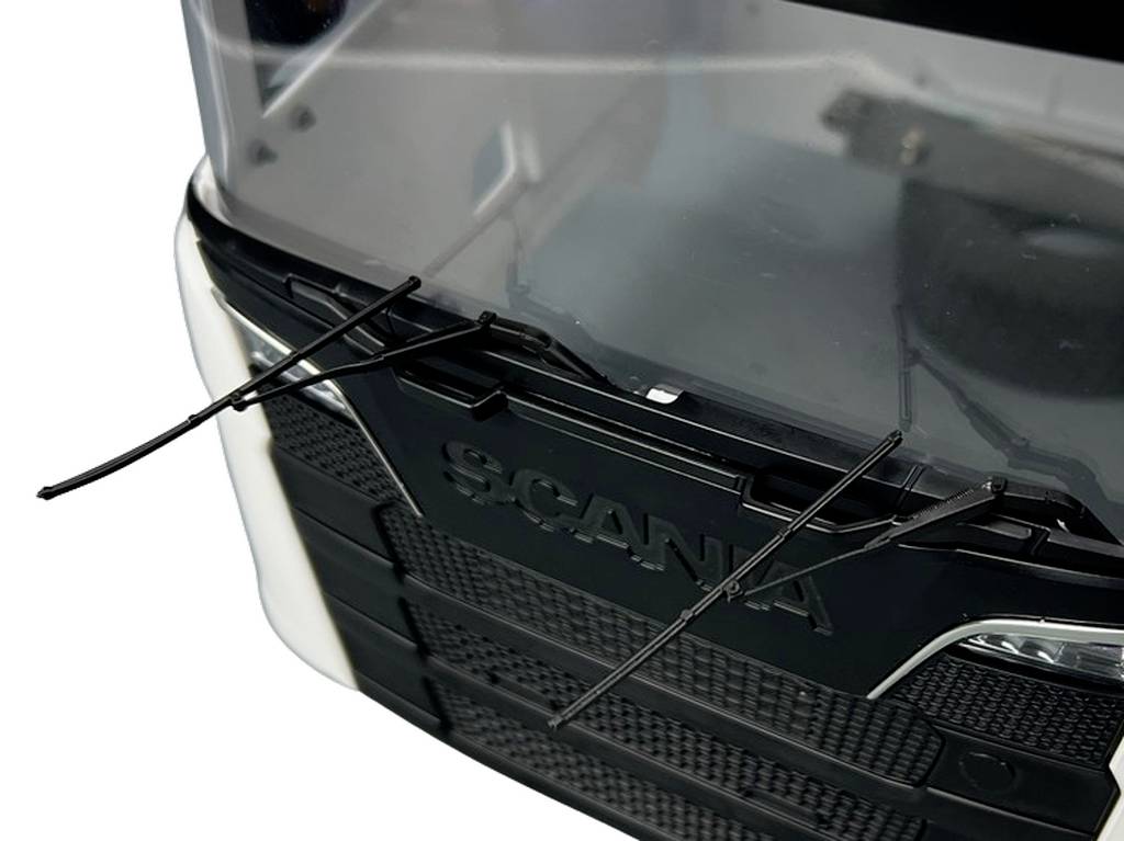 Close-up of a vehicle model with two black windscreen wipers on the windscreen and the 'Scania' marque.