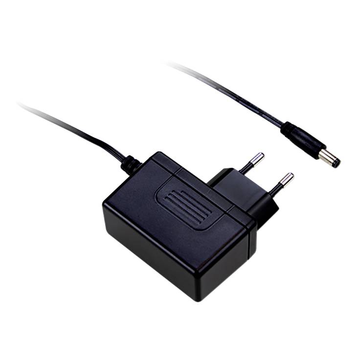 A black power supply with an EU plug and cable. It has a rectangular shape and is used to power electrical devices.