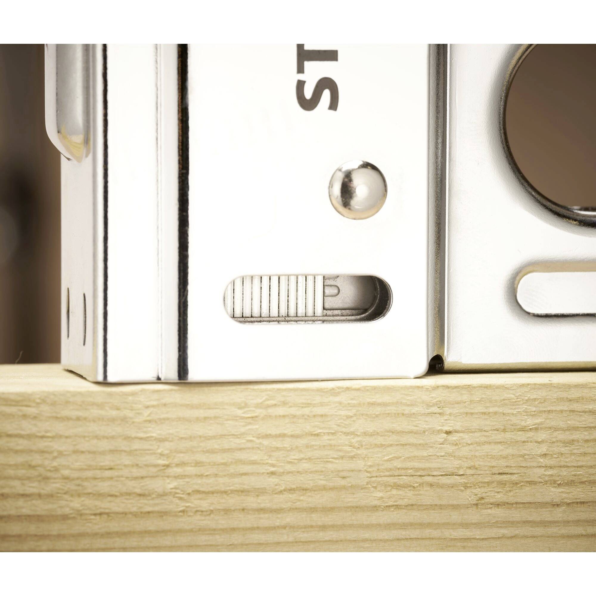 A silver spirit level on a wooden board indicates that the surface is level.