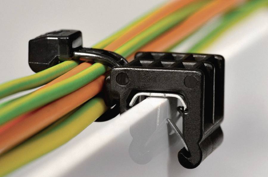 A cable clip holds colourful cables together on a white background, ensuring organisation and safety.