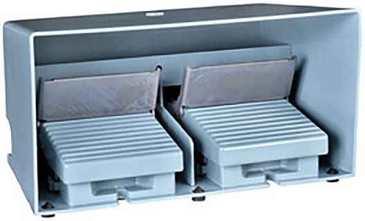 Two grey, parallel foot pedals in a protective housing, used for controlling machinery.