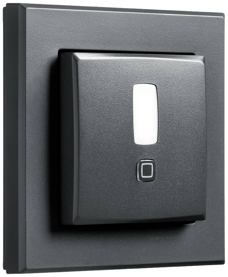 Light switch in close-up, black casing with white switch in the centre.
