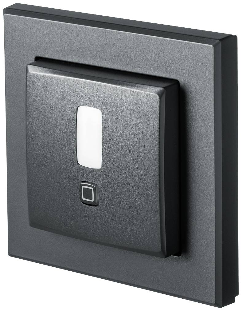 A modern, square light switch in black with a small, central white stripe indicates whether the switch is on or off.