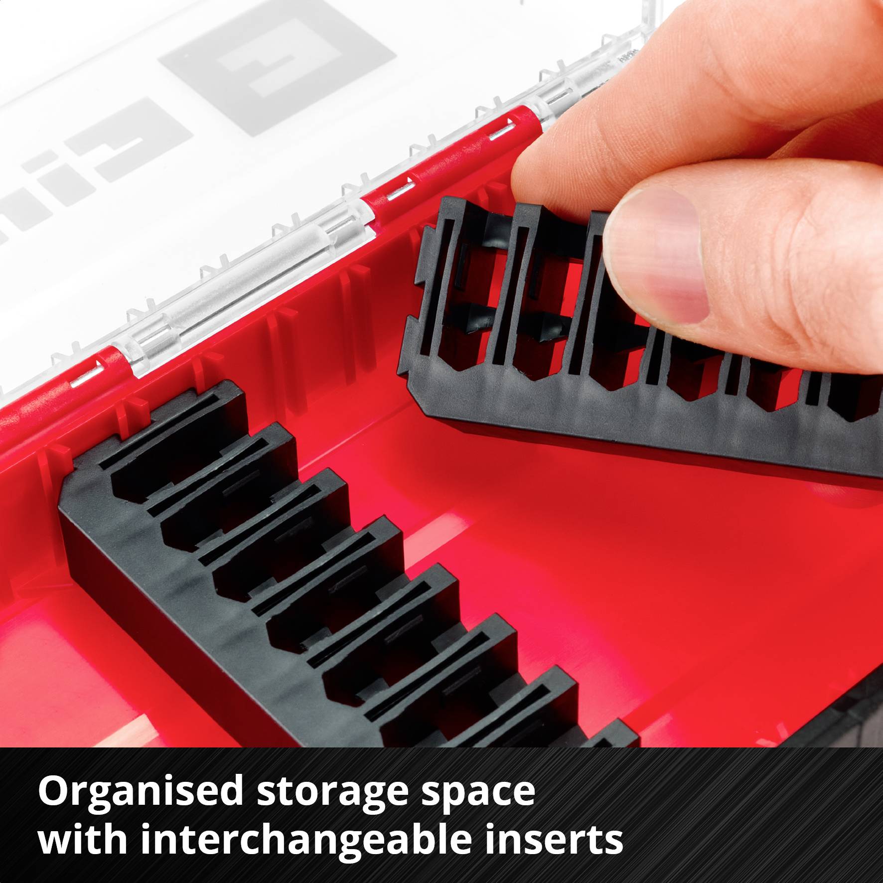 A hand places a black plastic insert into a red toolbox with interchangeable compartments. Text: 'Organised storage with interchangeable inserts'.