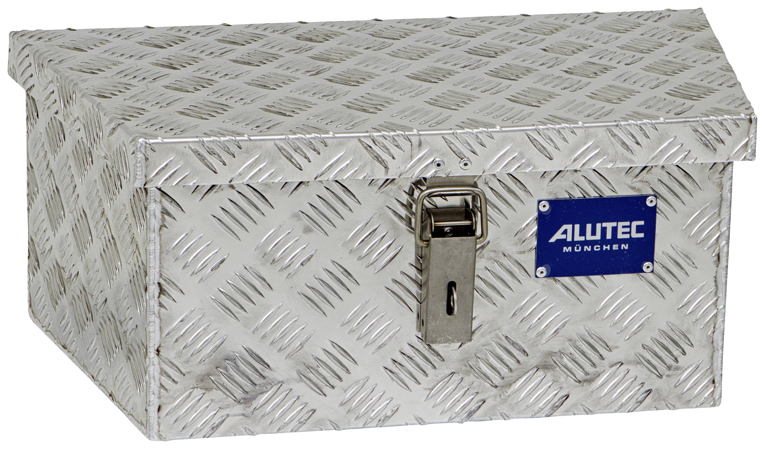 Metal box with diamond-patterned surface and lock, blue sign reading 'ALUTEC MÜNCHEN' on the side.