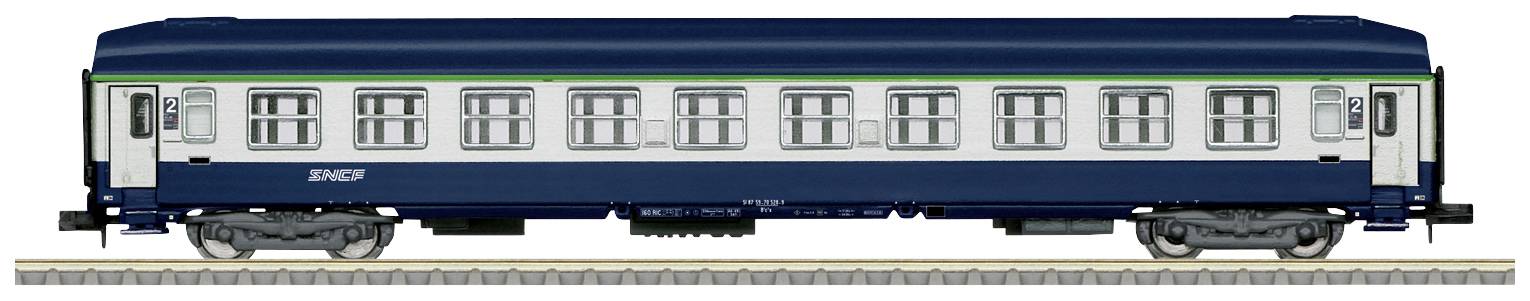 A blue railway carriage with a green line and white windows is standing on train tracks.
