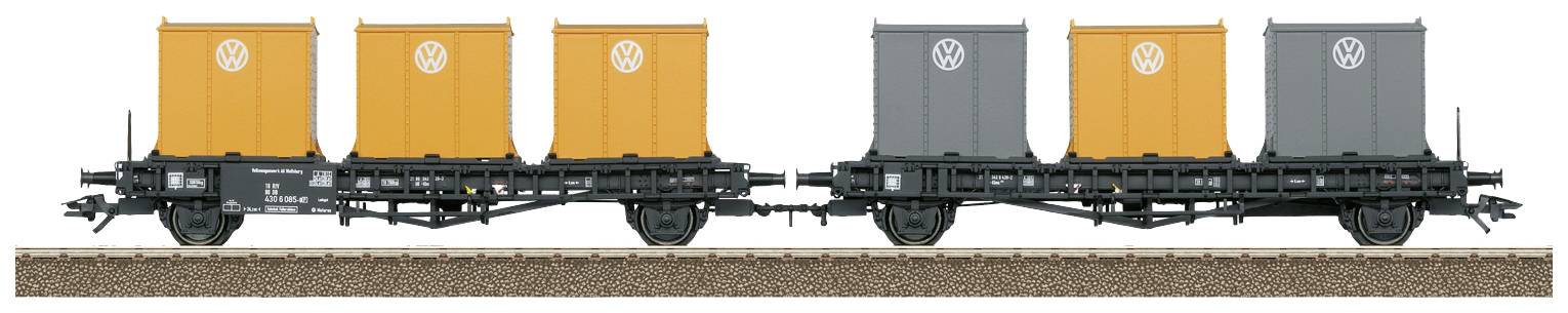 Two railway wagons with orange and grey containers bearing the Volkswagen logo are standing on a track.