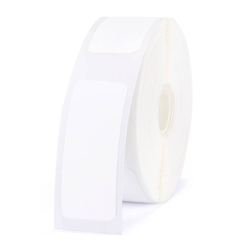 A roll of white labels without any printing, ready for writing or printing on.