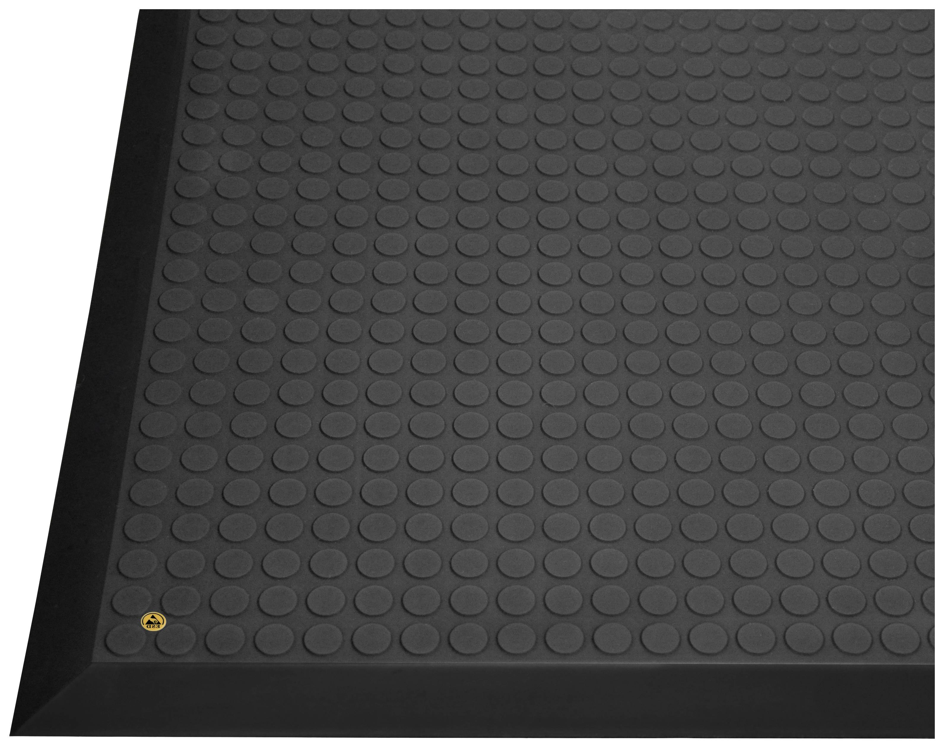 Black non-slip floor mat with circular raised areas and bevelled edges, visible in one corner.
