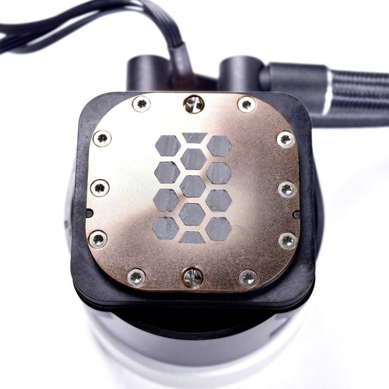 Copper cooling block with hexagonal pattern and screws, part of a computer liquid cooling solution for heat dissipation.