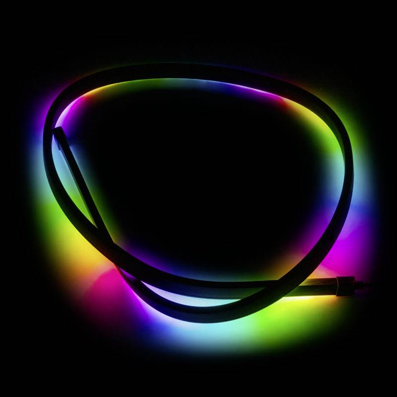 A luminous LED strip in various colours lies on a dark background. The colours shift and radiate evenly.