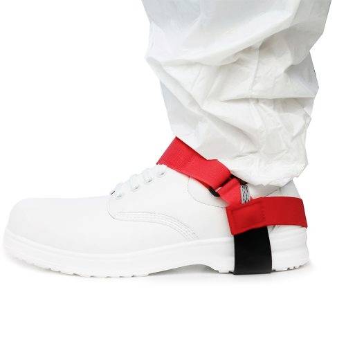White safety shoe with red heel strap and protective suit. The strap secures the trousers over the shoe to prevent tripping.