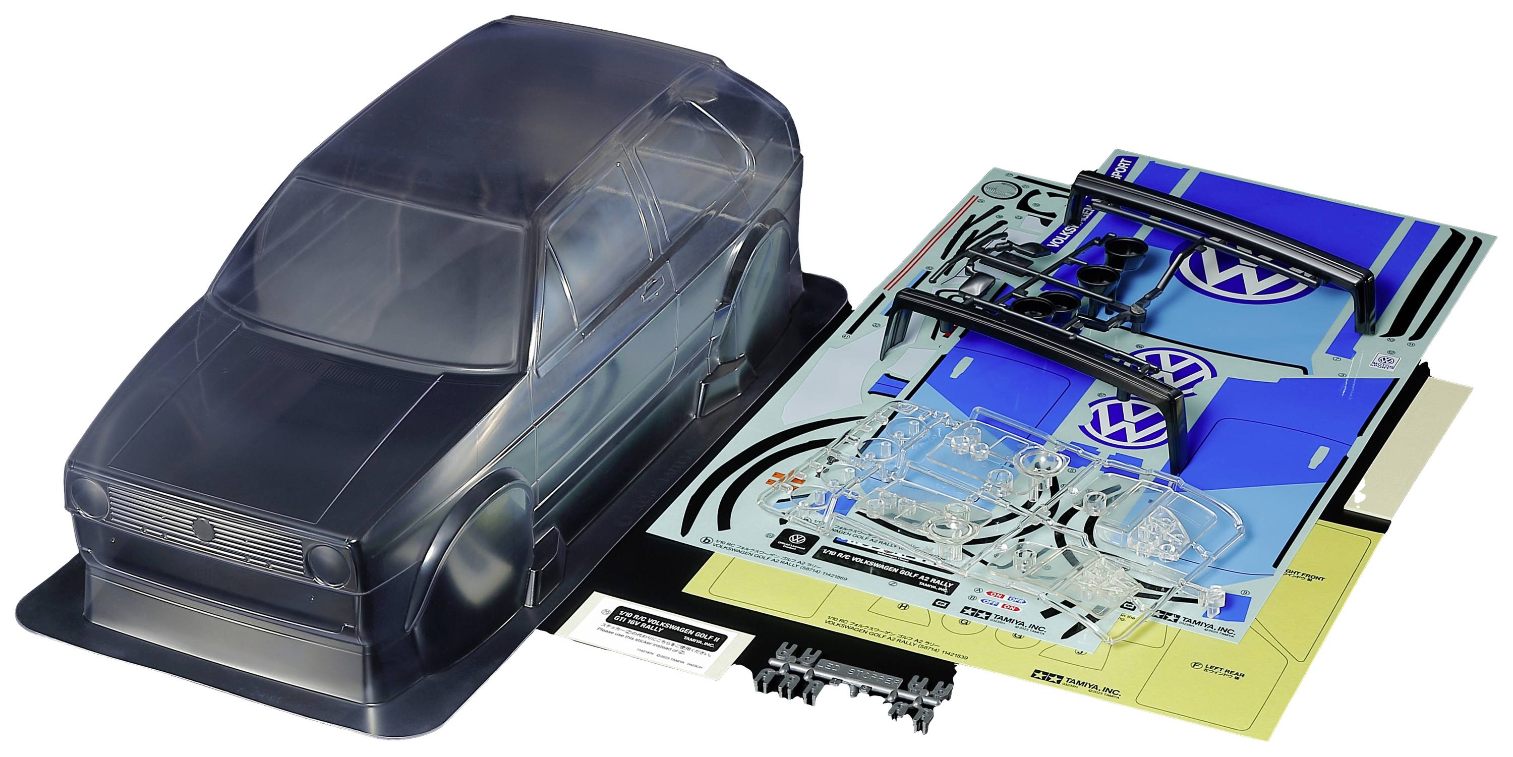 Plastic car body in a model kit with decal sheets and accessory parts.