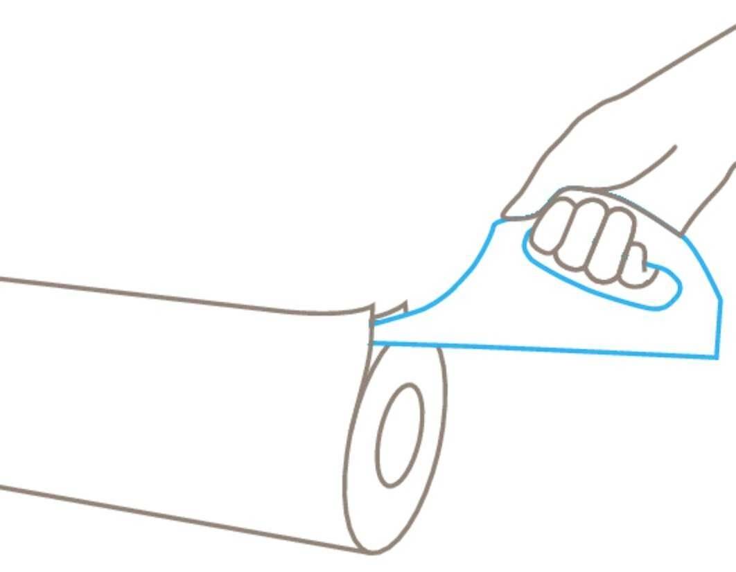 A hand tears off a piece of kitchen roll using a perforated edge.