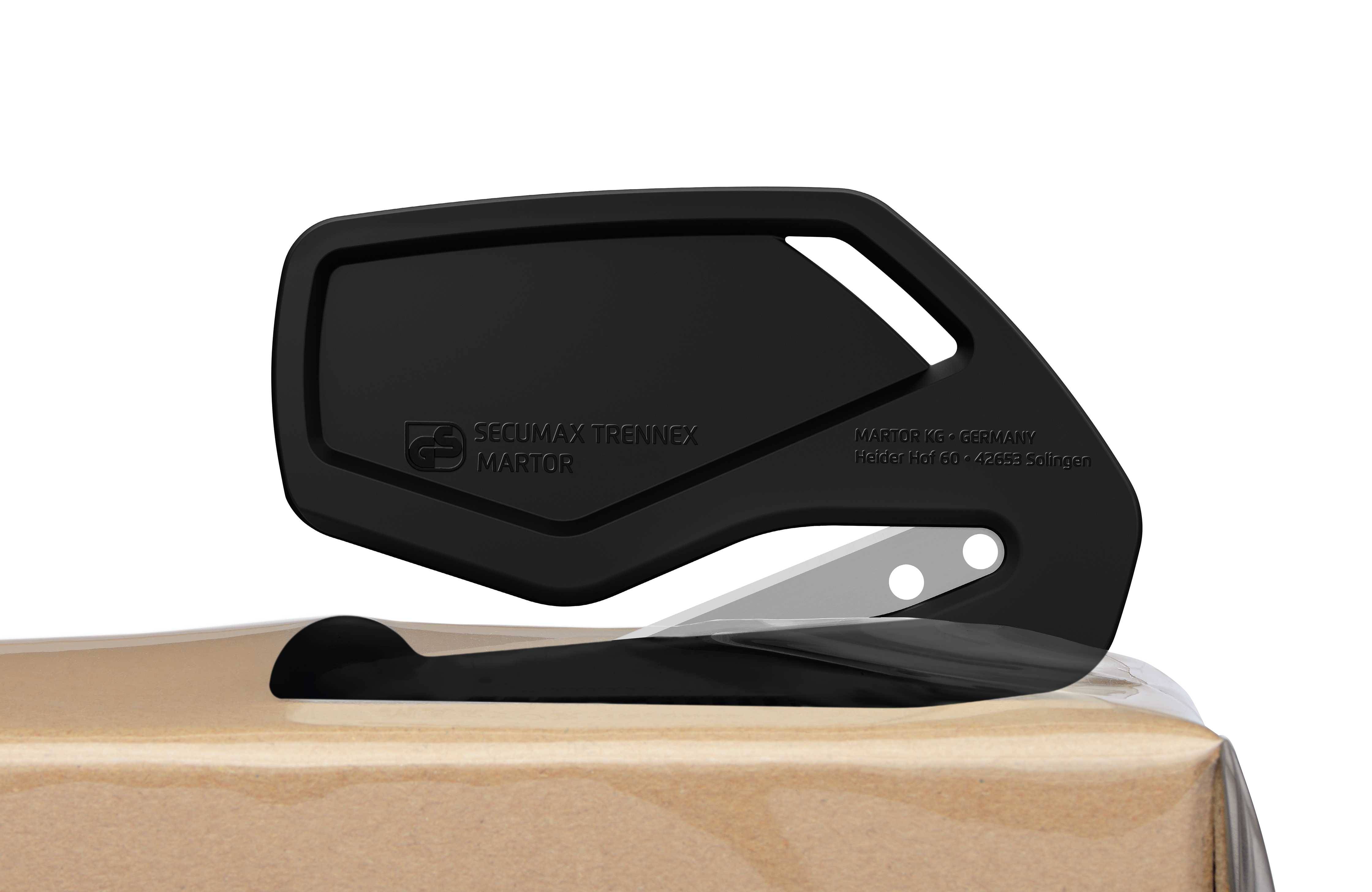 A black safety knife cuts through packaging tape on a cardboard box. The focus is on safe handling.