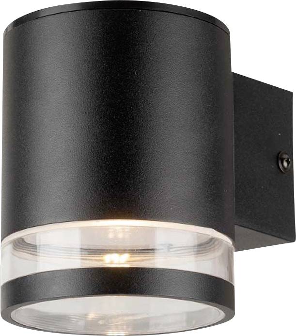 Black wall light with a cylindrical shape; a transparent element at the bottom that radiates light downwards. Modern exterior lighting.